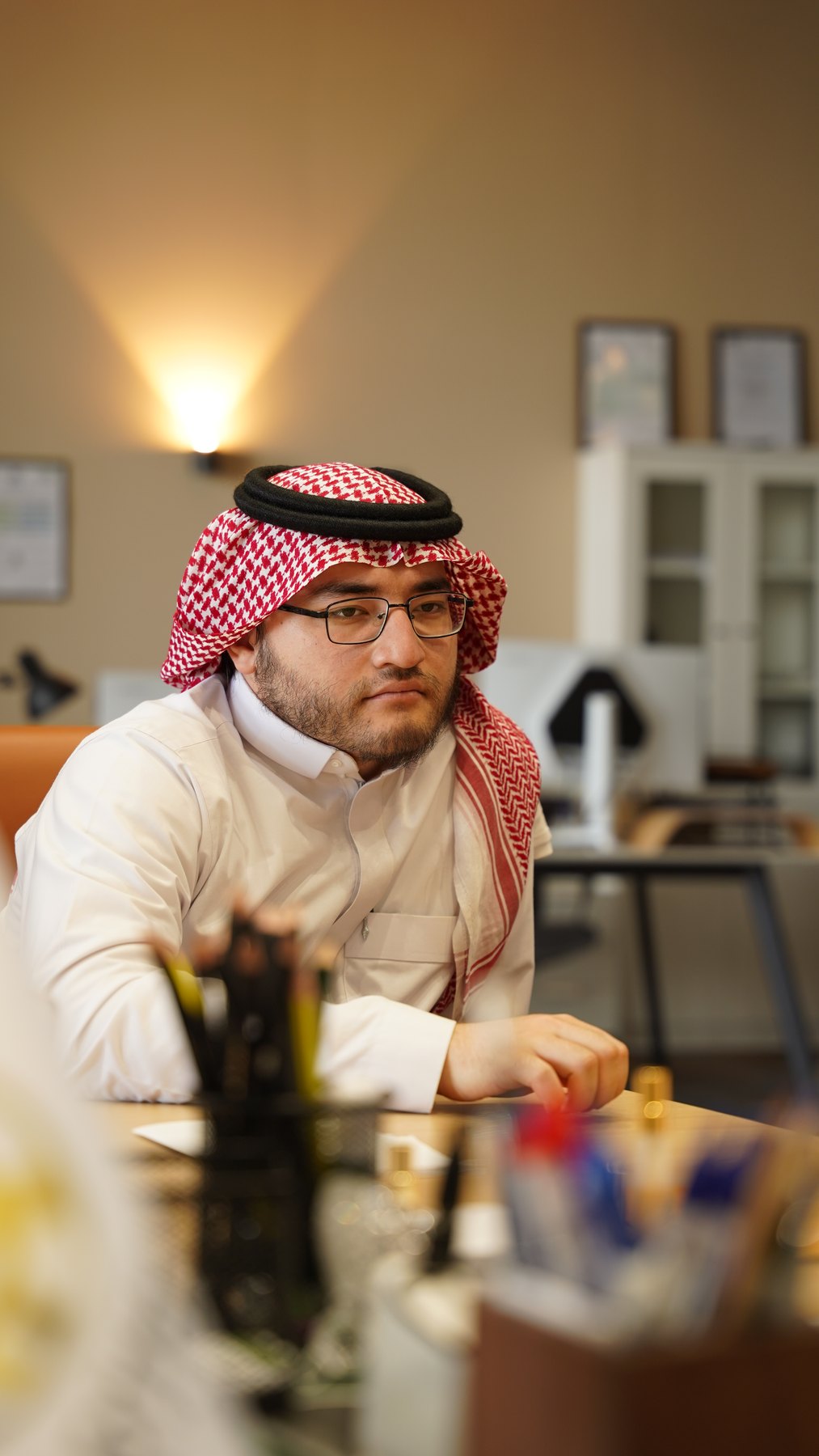 A Saudi partner at the Madinah office desk
