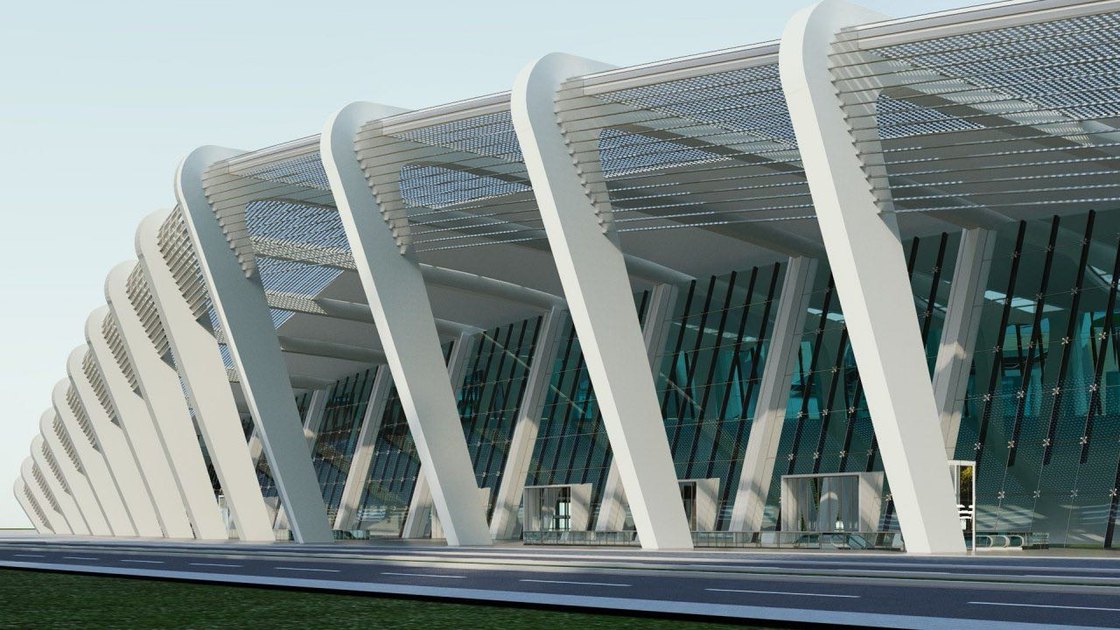 The exhibition hall's raking fins carrying a deep canopy over a fully glazed wall