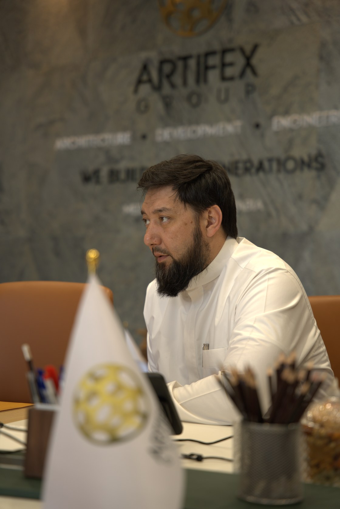 Rustam Khaitmetov beside the ARTIFEX GROUP wall