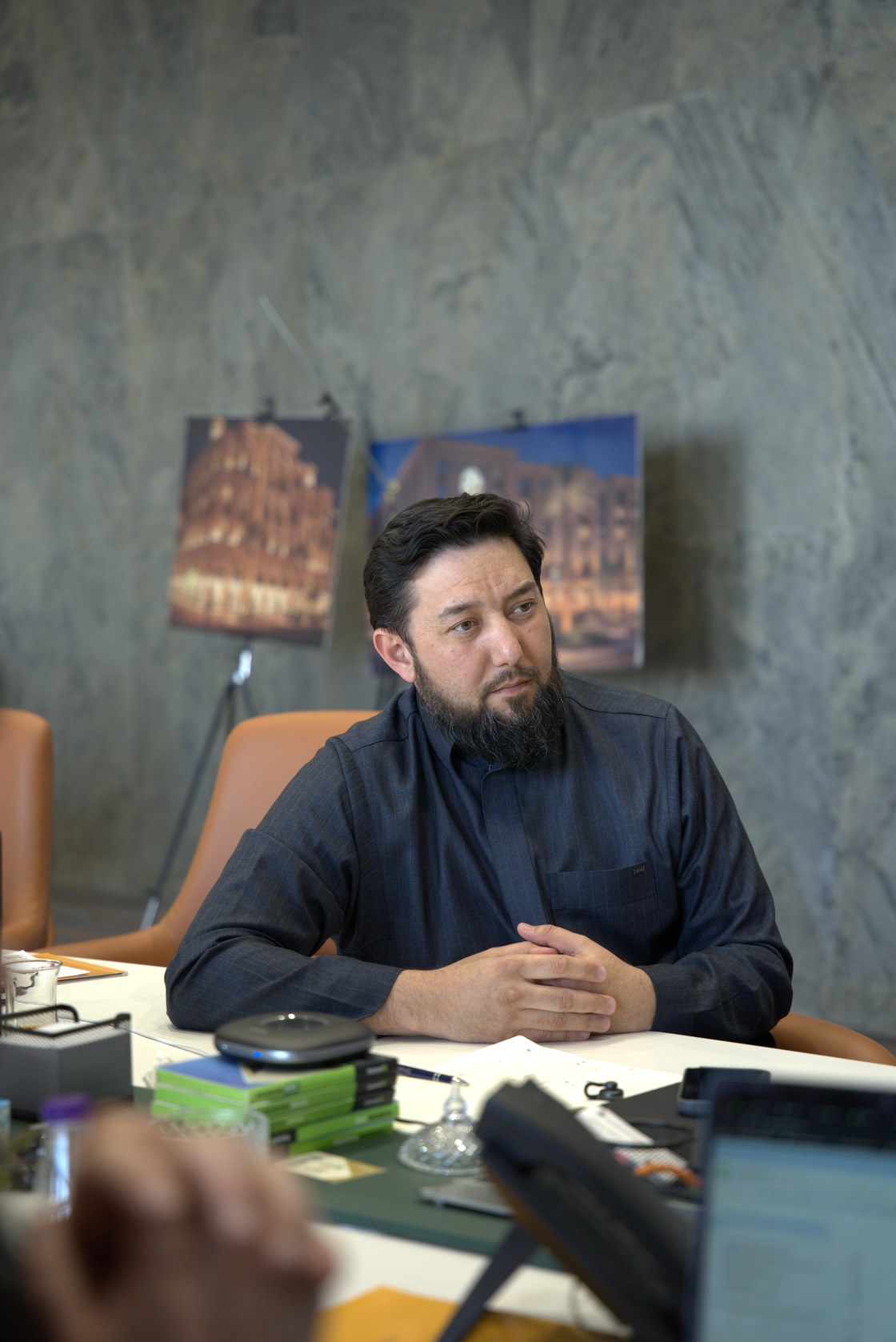 Rustam Khaitmetov at the desk in the Madinah office